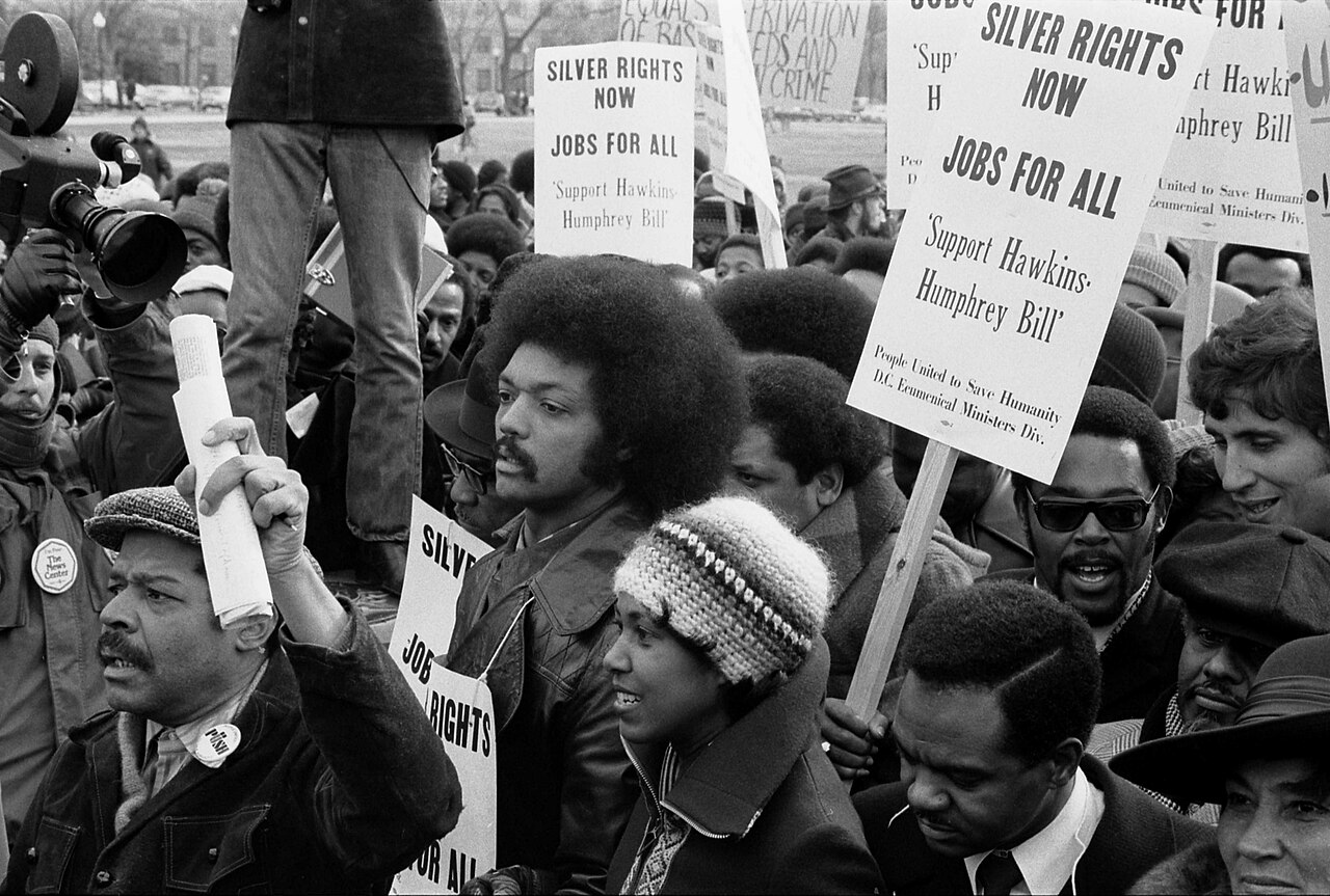 More details Jesse Jackson surrounded by marchers carrying signs advocating support for the Hawkins-Humphrey Bill for full employment,