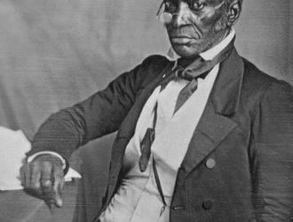 John Hanson of Liberia seated at a desk