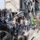Rescuers and residents searching the rubble of the destroyed Shajareh Tayyebeh elementary school in Minab
