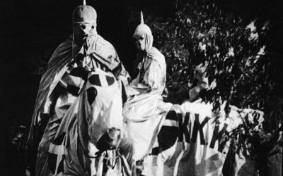 Actors dressed in ku klux klan costumes in a scene from the film the birth of a nation