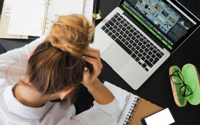 Work overload - woman sitting at desk stressed