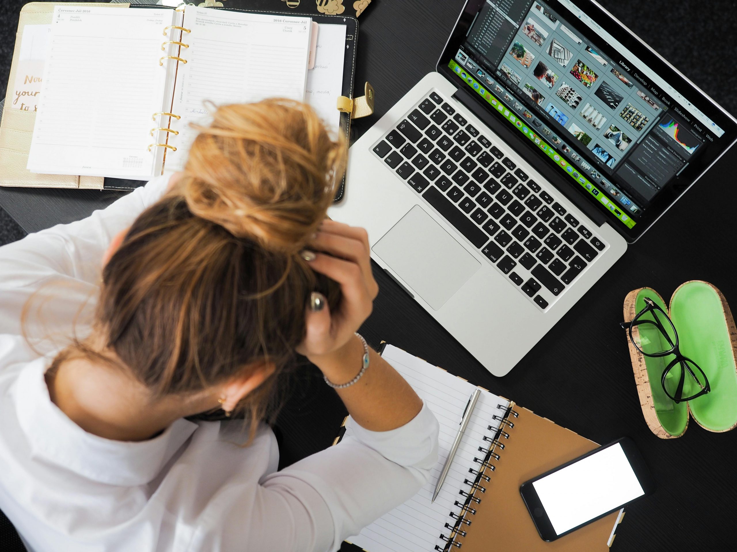 Work overload - woman sitting at desk stressed
