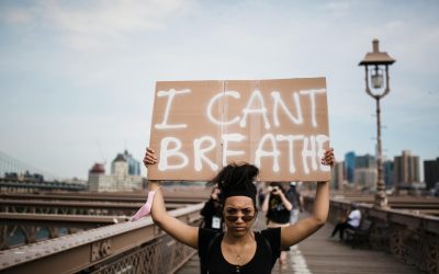 photo of woman carrying a cardboard