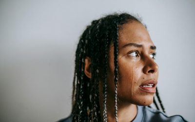 mournful black woman crying in light room