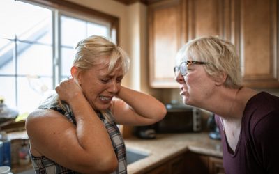woman in black tank top kissing woman in blue sleeveless top