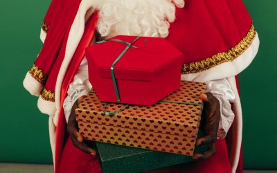 person in santa claus outfit holding gifts