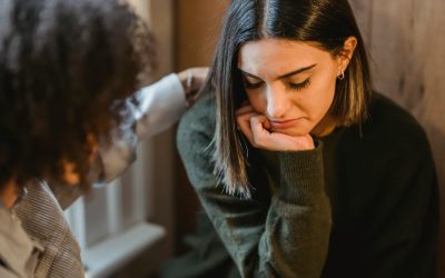 crop woman tapping shoulder of frustrated female friend