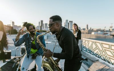 man playing saxophone next to a man dancing