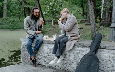 man and woman eating at a park