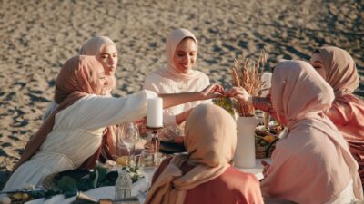 women in hijab having a picnic on the beach