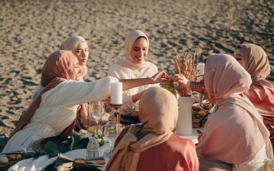 women in hijab having a picnic on the beach
